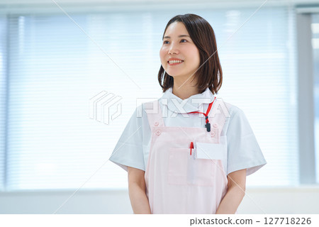 一位身穿白大褂和圍裙的女士 127718226
