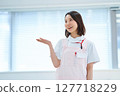 A woman in a white coat and apron 127718229