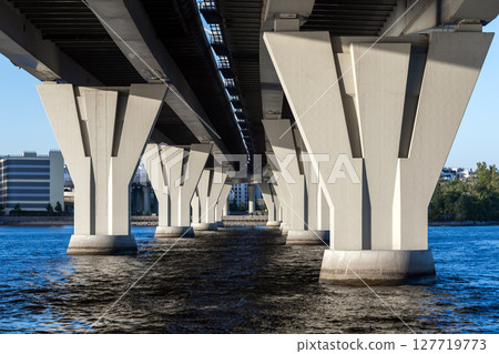 View of a contemporary bridge from beneath, showcasing its architecture View of a contemporary bridge from beneath, showcasing its architecture 127719773