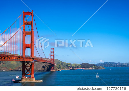 Golden Gate Bridge over blue waters with scenic hills in San Francisco 127720156