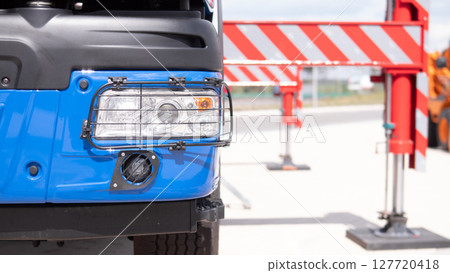A military vehicle is stationed in a war zone, equipped with a gun. The setting highlights the critical role of such vehicles in combat operations. 127720418