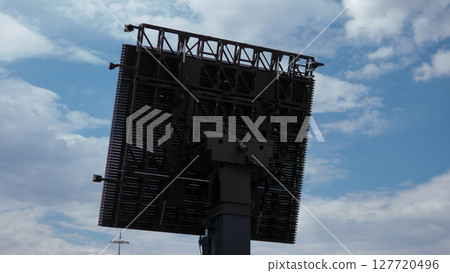 A military radar system stands tall in a warzone, providing surveillance and tracking capabilities amid a backdrop of overcast skies. A military radar system stands tall in a warzone, providing surveillance and tracking capabilities amid a backdrop of overcast skies. 127720496