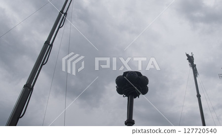 Surveillance equipment stands tall amidst dark clouds, as military forces monitor the area for potential threats during ongoing armed conflict. Surveillance equipment stands tall amidst dark clouds, as military forces monitor the area for potential threats during ongoing armed conflict. 127720540