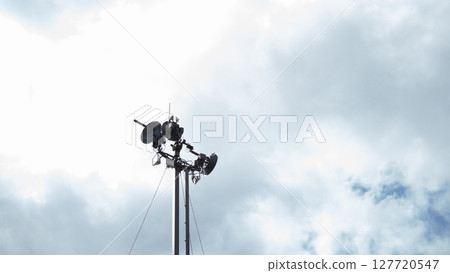 A communication tower looms against a backdrop of thick clouds, symbolizing the critical role of technology in military operations amid ongoing conflict. A communication tower looms against a backdrop of thick clouds, symbolizing the critical role of technology in military operations amid ongoing conflict. 127720547