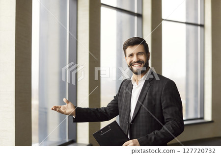 Sure confident smiling male realtor showing, real estate agent presenting apartment window, selling Sure confident smiling male realtor showing, real estate agent presenting apartment window, selling 127720732