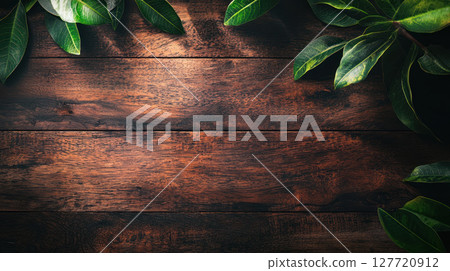 rustic wooden background with vibrant green leaves framing edges, creating natural and serene atmosphere, perfect for banners or advertisements 127720912