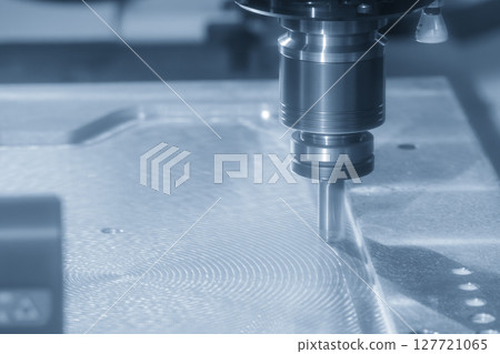 The CNC milling machine finish cut the aluminum housing parts with flat nose end mill tool in the light blue scene. 127721065