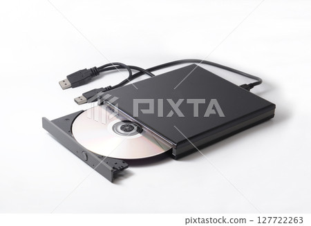 External DVD drive with a compact disc inside, used for DVD player or DVD burner, operated from a laptop or desktop using USB connector cable. Isolated on white. External DVD drive with a compact disc inside, used for DVD player or DVD burner, operated from a laptop or desktop using USB connector cable. Isolated on white. 127722263