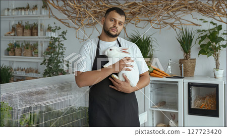 Mediterranean male pet shop seller in apron is Mediterranean male pet shop seller in apron is 127723420