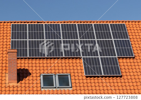 Solar panels on tiled house roof 127723808