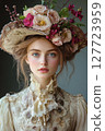 Portrait of a young woman adorned with a floral hat in a vintage-inspired outfit, captured in soft natural light showcasing delicate features 127723959
