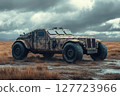 Vintage off-road vehicle rests in a desolate landscape under moody clouds, surrounded by tall grass on an overcast day 127723966