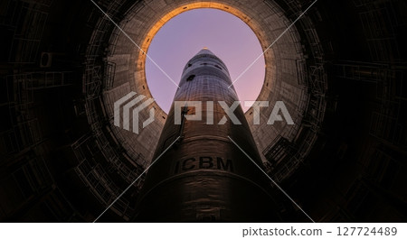 Intercontinental ballistic missile icbm standing vertically in a dark launch silo 127724489