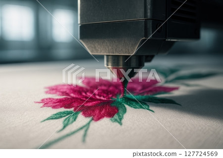 Advanced textile printing machine creating a vibrant pink flower design on white fabric with precision 127724569