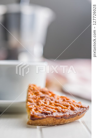 Sweet almond pie on white table. 127726028