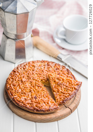 Sweet almond pie on white table. 127726029