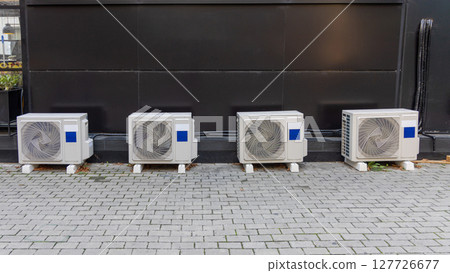 Air Conditioners Behind Building 127726677