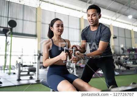 Personal Trainer Demonstrating Rowing Technique to Client Personal Trainer Demonstrating Rowing Technique to Client 127726707
