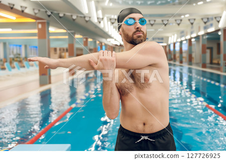 Man having a workout in the swimming pool Man having a workout in the swimming pool 127726925