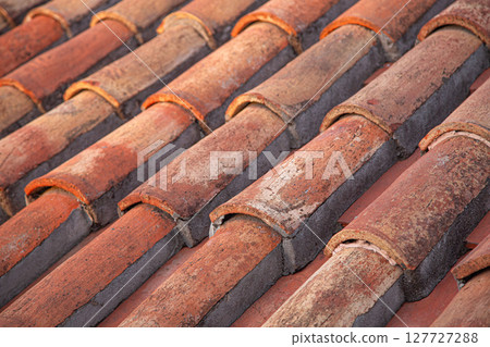 Close-up of terracotta roof tiles creating a textured surface 127727288