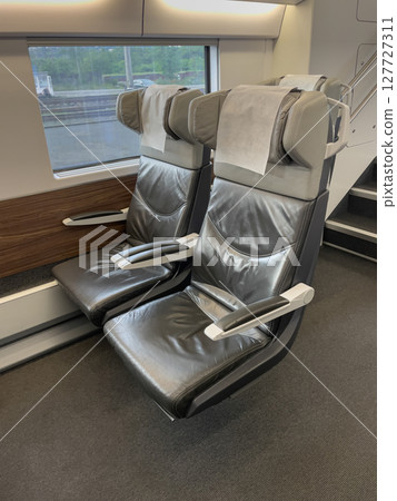 Comfortable seats inviting passengers aboard modern high-speed train 127727311