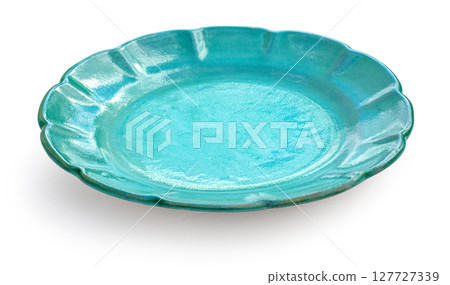 Empty teal ceramic plate with scalloped edge on white background Empty teal ceramic plate with scalloped edge on white background 127727339