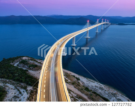 Aerial view of modern Peljesac bridge and blue sea at night 127727782