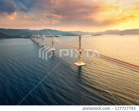 Aerial view of modern Peljesac Bridge and blue sea at sunset 127727783