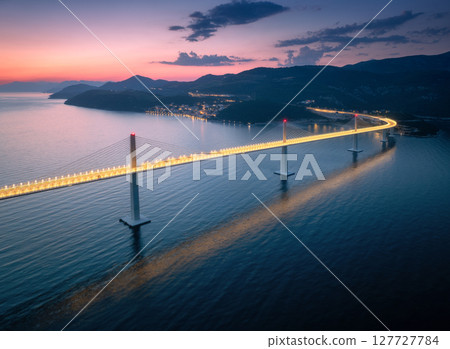 Aerial view of modern Peljesac bridge and blue sea at night 127727784
