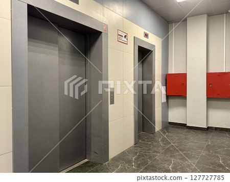 cargo and passenger elevators in the entrance of an apartment building. High quality photo 127727785