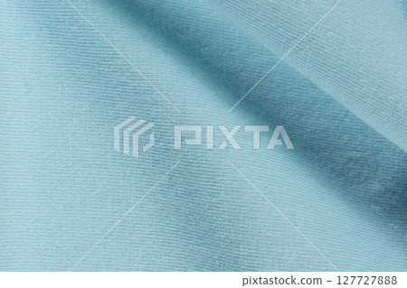 Macro texture of blue fabric consisting of cotton with a slight addition of spandex. Macro texture of blue fabric consisting of cotton with a slight addition of spandex. 127727888