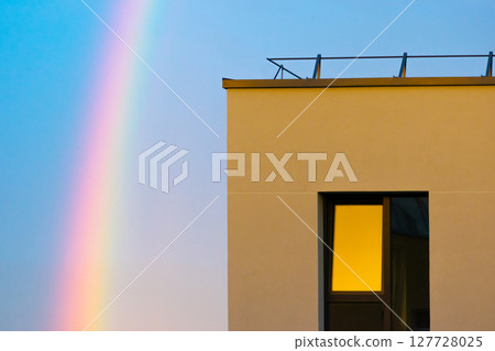 Rainbow in the sky and flat apartment window 127728025