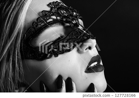 Portrait of beautiful woman with black lace mask on her eyes Portrait of beautiful woman with black lace mask on her eyes 127728166