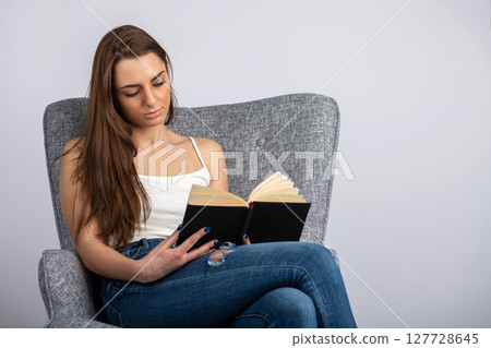 Portrait of beautiful woman reading book 127728645
