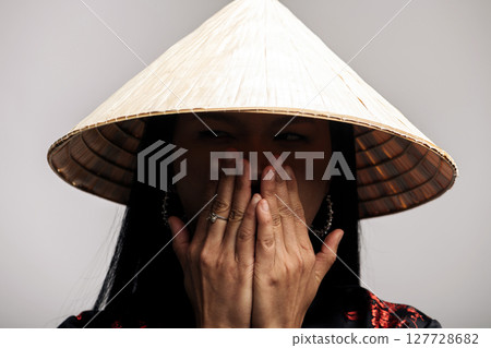 Portrait of Asian woman with cone-shaped Asian cane hat Portrait of Asian woman with cone-shaped Asian cane hat 127728682