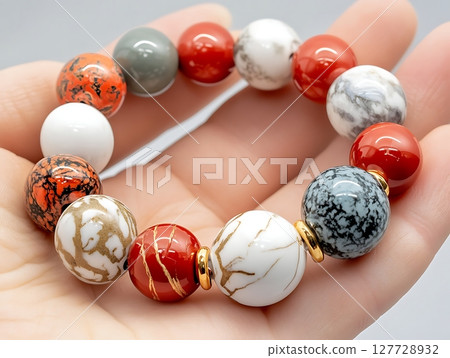 Vibrant Gemstone Bracelet Showcasing Unique Colorful Beads in Hand 127728932