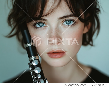 Portrait of a Woman Holding a Clarinet with Grace 127728948