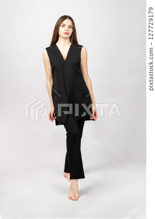 Classic beautiful woman with black outfit studio portrait 127729179