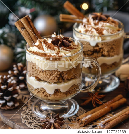Gingerbread tiramisu in glass mugs with cinnamon and star anise, festive holiday table setting. 127729289