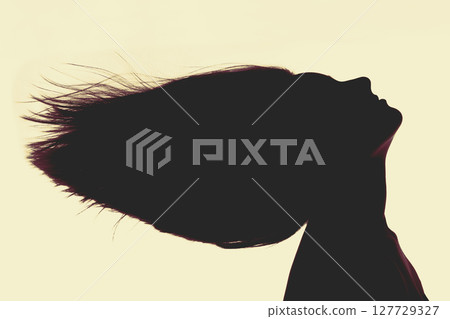 Woman black face silhouette with flying hairs Woman black face silhouette with flying hairs 127729327