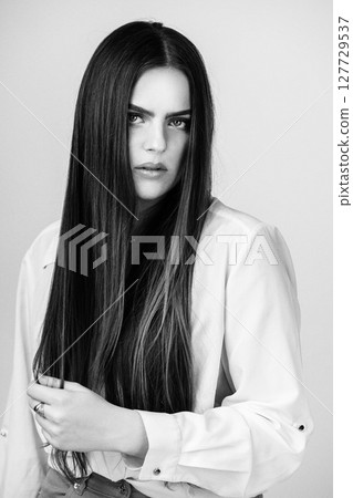 Beautiful woman with long dark hair studio portrait Beautiful woman with long dark hair studio portrait 127729537