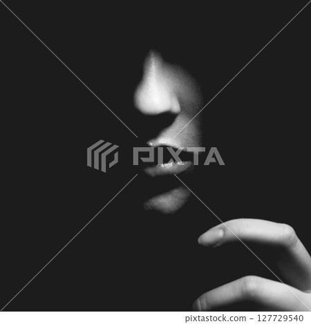 Part of woman face in black shadow background 127729540