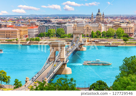 Famous Chain Bridge over blue Danube in Budapest with St. Stephen's basilica view, Hungary 127729546