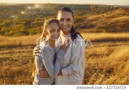 Happy Mother And Daughter Embracing In Nature 127729714