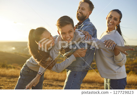 Happy family nature outdoor trip, spending weekend holiday together, parents, children enjoy time  127729823