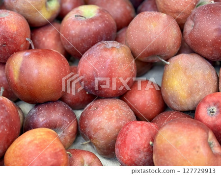 Box filled with fresh natural bio organic red apples placed on counter in local food market 127729913