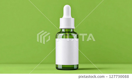Glass dropper bottle on solid green background with blank label for mockup ready for labeling and product design 127730088