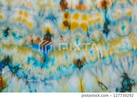 abstract pattern on silk fabric texture in blue, yellow, green colors 127730292