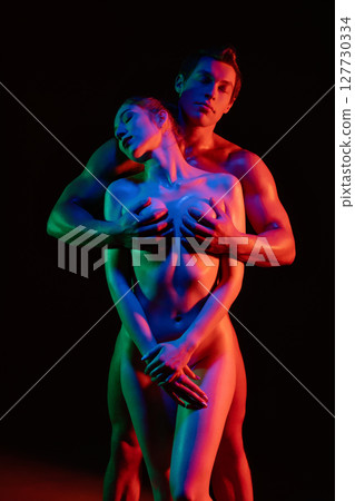 Artistic portrayal of intimacy with vibrant lighting at night 127730334