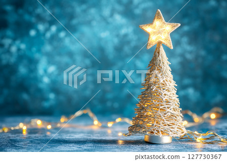 Christmas and New Year background with a golden Christmas tree and a star with copy space for your text. 127730367